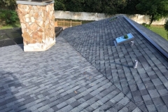 An aerial view of gray asphalt shingle roof replacement job