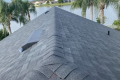 An aerial view of a new roof with gray asphalt shingles installed on a home in Florida.