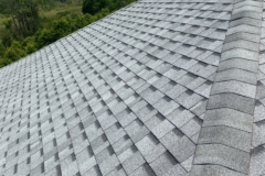grey-roofing-shingle-with-sky-in-background